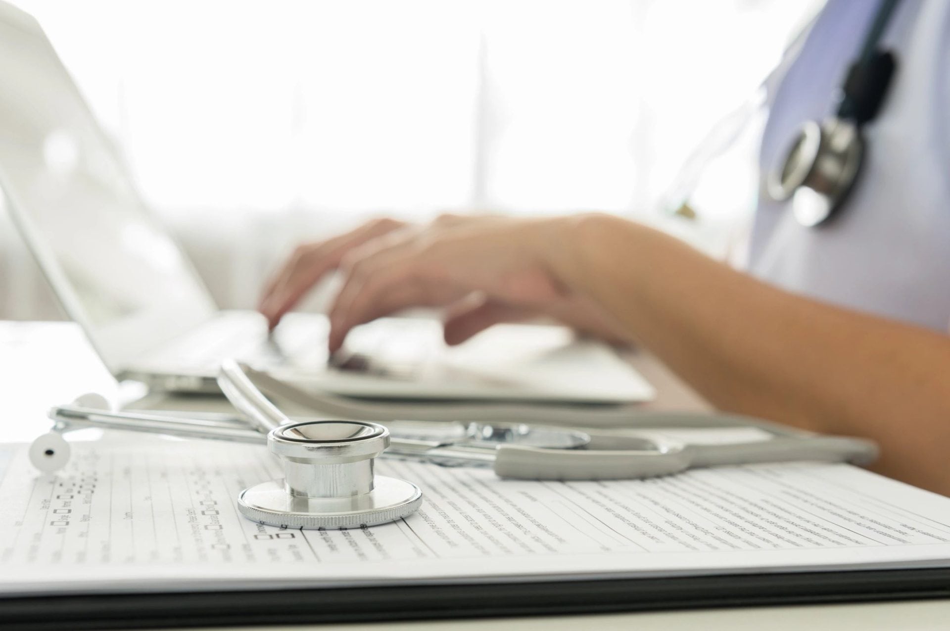 Smiling doctor in white coat at a desk